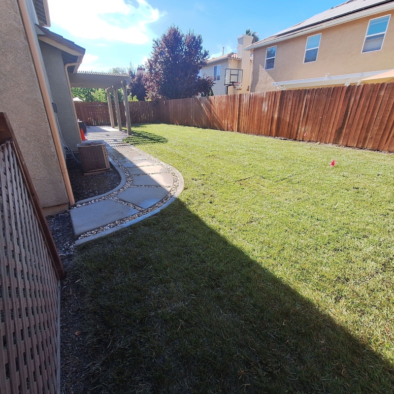 A newly installed paver patio with intricate stonework, ready for outdoor furniture