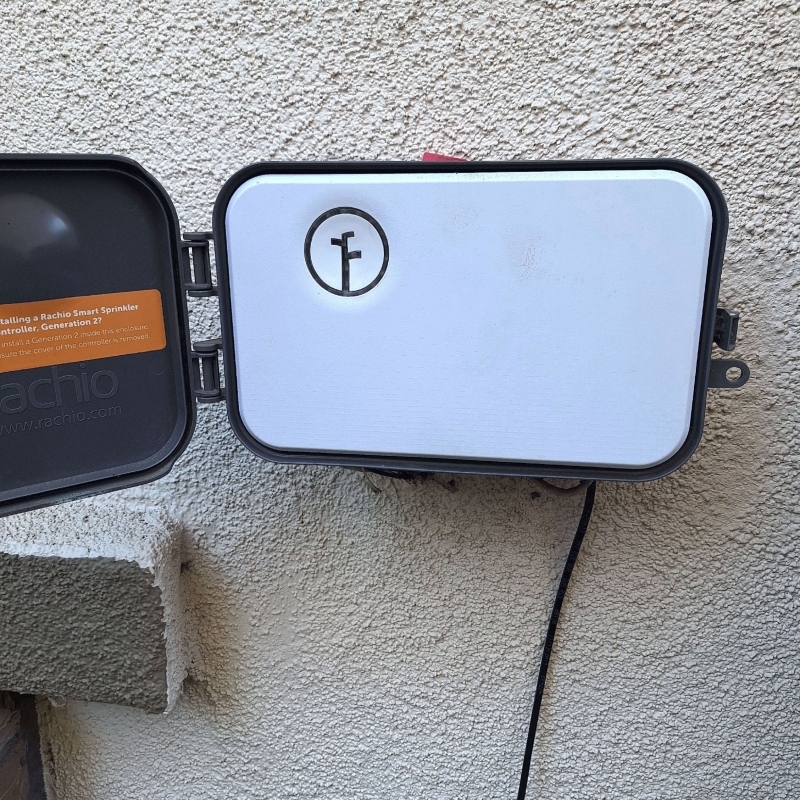 A uniformed landscaping crew planting shrubs along a commercial property walkway