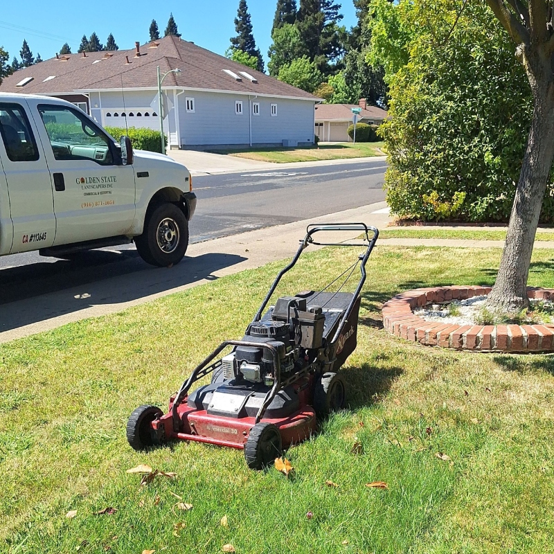 Close-up of a core aeration machine removing plugs of soil to improve lawn health