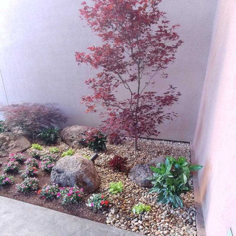 Family enjoying their newly designed backyard living space with a fire pit and seating area