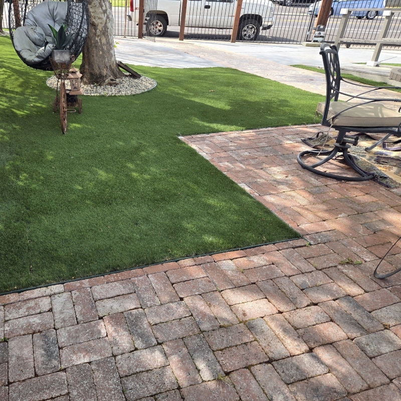 Lawn care professional using a push mower to create perfect stripes on a green residential lawn Lawn care professional using a push mower to create perfect stripes on a green residential lawn