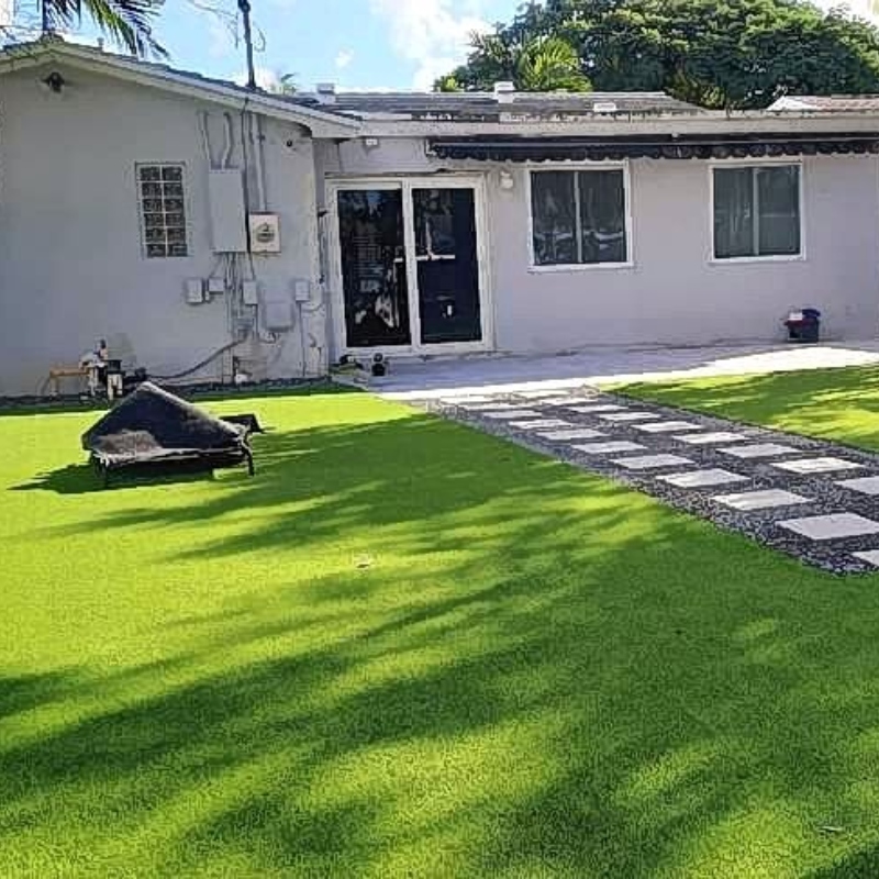 Subtle, warm landscape lighting illuminating a garden path and trees at dusk